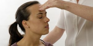 Kinesiologist or physiotherapist treating Neuro vascular holding - emotional stress release